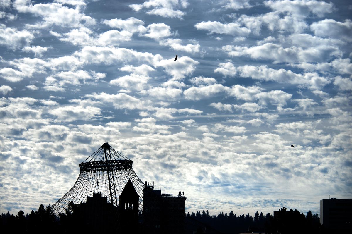 Under a blanket of altocumulus clouds, the U.S. Pavilion and the Clock Tower in Riverfront Park dominate the Spokane skyline. (Dan Pelle / The Spokesman-Review)