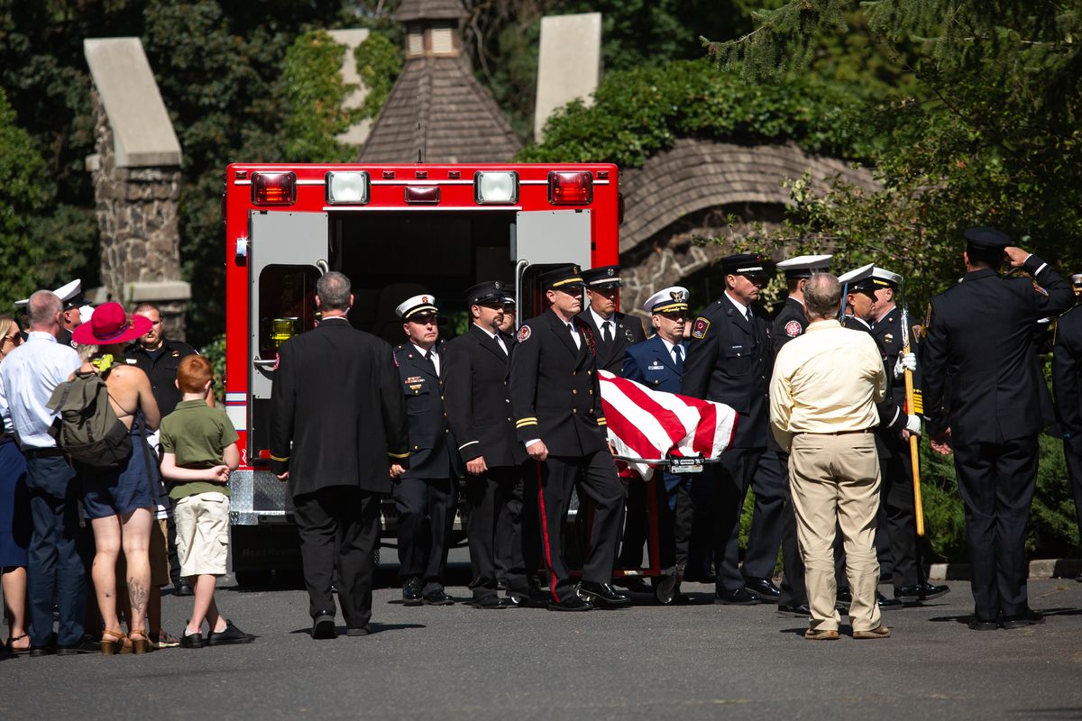Firefighters carry the body of 18-year career firefighter Lt. Cody Traber into Heritage Funeral Home during a formal procession on Tuesday, Aug. 31, 2021 in Spokane, Wash. On Aug. 26, Spokane County Fire District 9, Engine 92, was dispatched to a call and Traber fell from the Wandermere while attempting to gain a better vantage point. Traber is survived by a wife and four young children, as well as the departments he previously served with including Stevens County Fire District 1, Cheney Fire Department, Spokane County Fire District 4, the Washington Department of Natural Resources: Arcadia District.  (Libby Kamrowski/ THE SPOKESMAN-R)