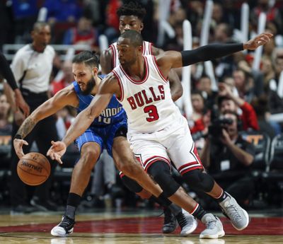 Chicago Bulls guard Dwyane Wade, right, battles for the ball with Orlando Magic guard Evan Fournier, left, during the second half of an NBA basketball game, Monday, Nov. 7, 2016, in Chicago. (Kamil Krzaczynski / Associated Press)