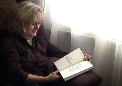 
At her Spokane Valley home last week, Maryann Ferry looks at her poem, 