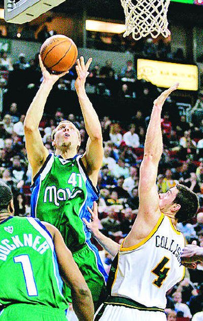 
Dallas' Dirk Nowitzki scores over Seattle's Nick Collison on Wednesday in Seattle.
 (Associated Press / The Spokesman-Review)