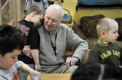 Anthony Johnstone, a mentor for Hillyard Head Start in the Foster Grandparent Program, gives comfort to Phillip Webber during activities time on Friday. “Grandpa T.J.,” as Johnstone is known, spends five hours a day at the program, four times a week.  (Dan Pelle / The Spokesman-Review)