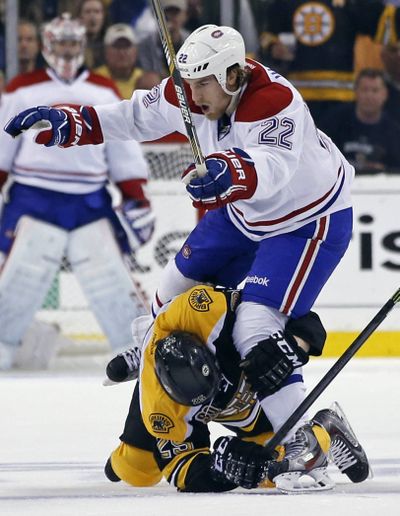 Boston’s Matt Fraser grabs Montreal right wing Dale Weise (22) around the leg during the third period of Game 7 Wednesday. (Associated Press)