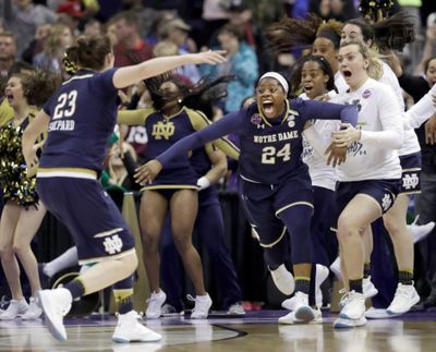 Notre Dame's Arike Ogunbowale (24) is congratulated by teammate Jessica Shepard (23) after sinking a 3-point basket to defeat Mississippi State 61-58 in the final of the women's NCAA Final Four college basketball tournament, Sunday, April 1, 2018, in Columbus, Ohio. (Tony Dejak / AP)