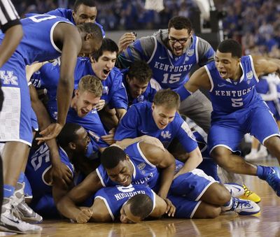 It’s a dog pile of Wildcats after 74-73 Final Four win over Wisconsin that was capped by Aaron Harrison’s 3-pointer with 5.7 seconds left. (Associated Press)