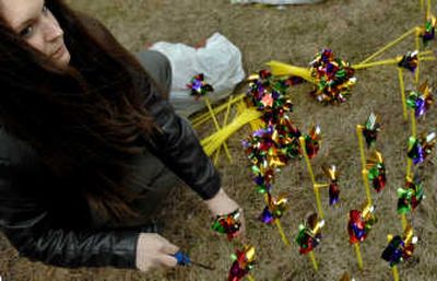 
Kathleen Fairbanks plants pinwheels on Monday to represent foster children in North Idaho. 
 (Kathy Plonka / The Spokesman-Review)