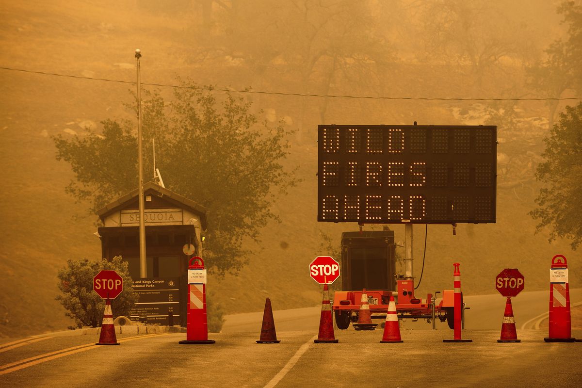 Cones block the entrance to Sequoia National Park, Calif., as the KNP Complex Fire burns nearby on Wednesday, Sept. 15, 2021. The blaze is burning near the Giant Forest, home to more than 2,000 giant sequoias. (Noah Berger)