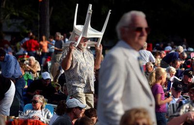 
Peter O'Dell, of Harrison, Idaho, maneuvers through a sea of people to find a place to sit at the Spokane Symphony Orchestra's Labor Day concert in Comstock Park. 
 (Liz Kishimoto / The Spokesman-Review)