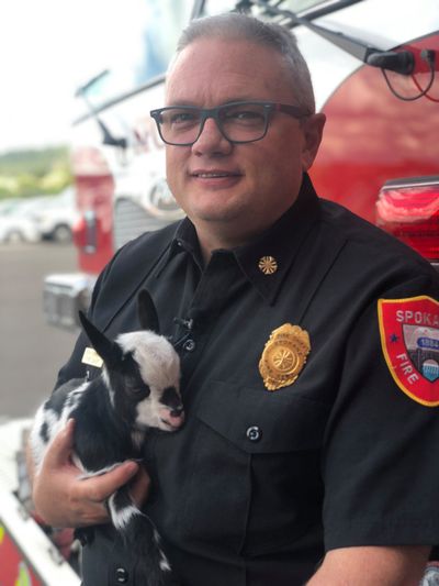 Spokane Fire Chief Brian Schaeffer holds a young goat in this photo shared on the department’s Facebook page.  (Adam Shanks / The Spokesman-Review)