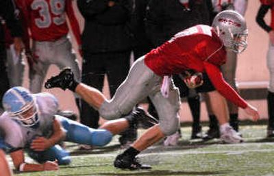 
Ferris quarterback Jeff Minnerly picks up a crucial first down in the fourth quarter, helping to seal the Saxons' win. 
 (Brian Plonka / The Spokesman-Review)