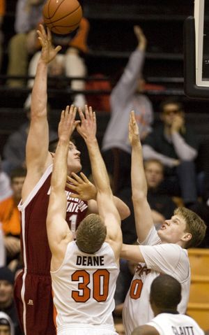 Washington State center Aron Baynes, left, shoots over Oregon State's Daniel Deane (30) and Roeland Schaftenaar during the second half of an NCAA basketball game in Corvallis, Ore., Thursday, Jan. 15, 2009.  Baynes led Washington State with 17 points to beat Oregon State in overtime 61-59. (Associated Press)