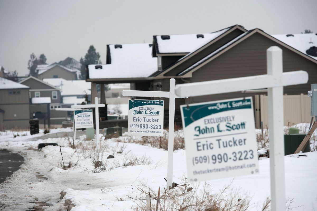 “For sale” signs line a street in the Morningside development in Spokane Valley on Friday, Jan. 25, 2019. About 1,500 single-family housing permits were issued last year for the Spokane area, but housing inventories aren’t keeping up with demand from buyers. (Kathy Plonka / The Spokesman-Review)