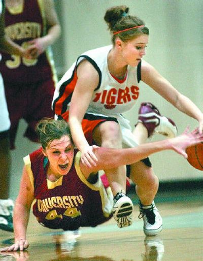 
University's Leah Archibald, left, and Lewis and Clark's Daisy Burke go all out for a loose ball. 
 (Brian Plonka / The Spokesman-Review)