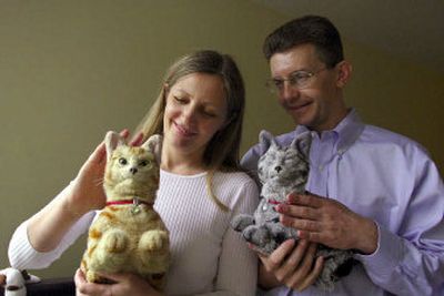 
Psychologists Elena and Alex Libin, of Washington, D.C., use robotic cats like Cleo and Max in therapy. 
 (Washington Post / The Spokesman-Review)