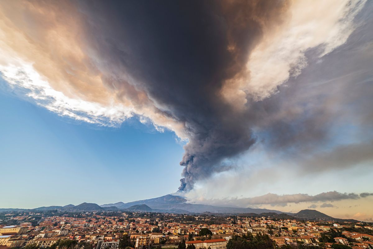 Volcanic ashes ascend from the southeastern crater of the Mt. Etna volcano as seen from Pedara, Sicily, Italy, Monday, Feb. 21, 2022. The second-strongest paroxysm of 2022 produced volcanic smoke and ashes that rose for 10 kilometers (6.2 miles) forcing the temporary closure of the nearby Vincenzo Bellini international airport in Catania.  (Salvatore Allegra)