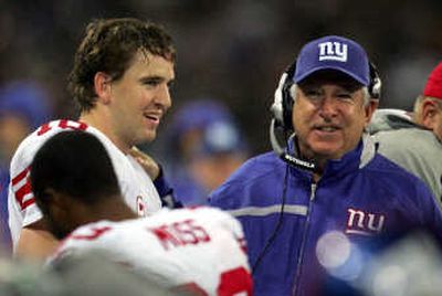 
Giants' Eli Manning, left, talking to a coach in London. Associated Press
 (Associated Press / The Spokesman-Review)