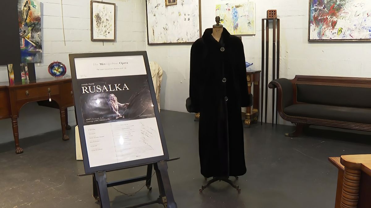 FILE - In this image from video, a black mink fur coat, right, and a signed opera poster belonging to the late Justice Ruth Bader Ginsburg, are seen inside Potomack Company Auctions in Alexandria, Va., Monday, April 11, 2022. An online auction of 150 of items owned by Ginsburg raised $803,650 for Washington National Opera. The opera was one of the late justice’s passions.  (Nathan Ellgren)