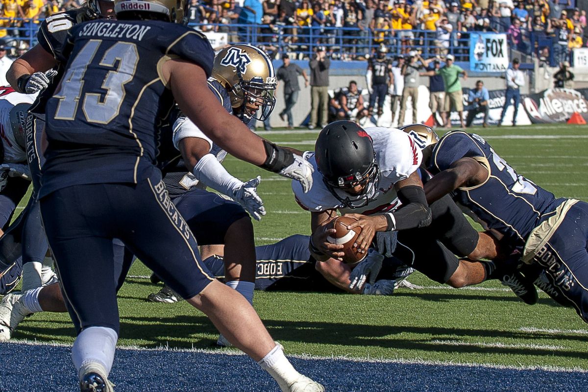 EWU quarterback Vernon Adams scores winning conversion. (Associated Press)