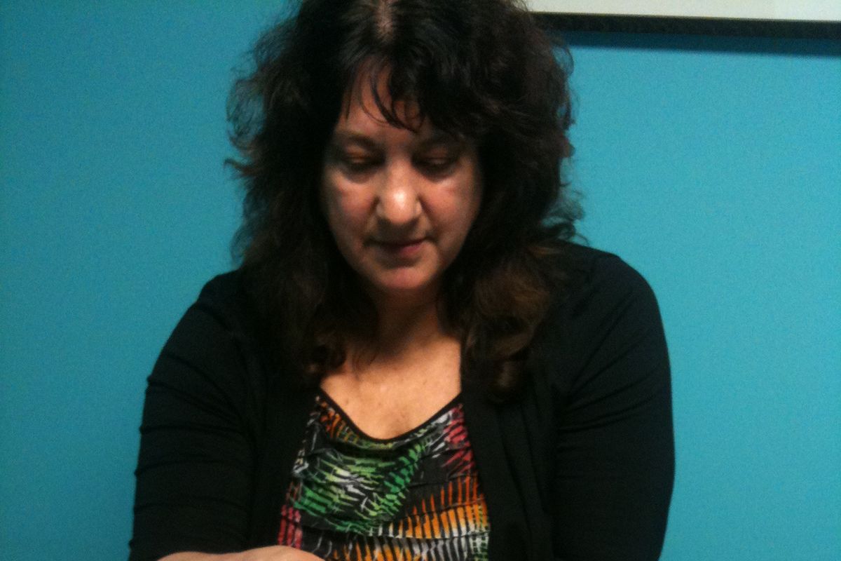 Nancy Lee, LMP, and owner of Northwest Noetic School of Massage and Education Center, demonstrates a cranial technique on Connie Williams, a Licensed Massage Practitioner and school alumna.  (Courtney Dunham  / Down to EarthNW Correspondent)