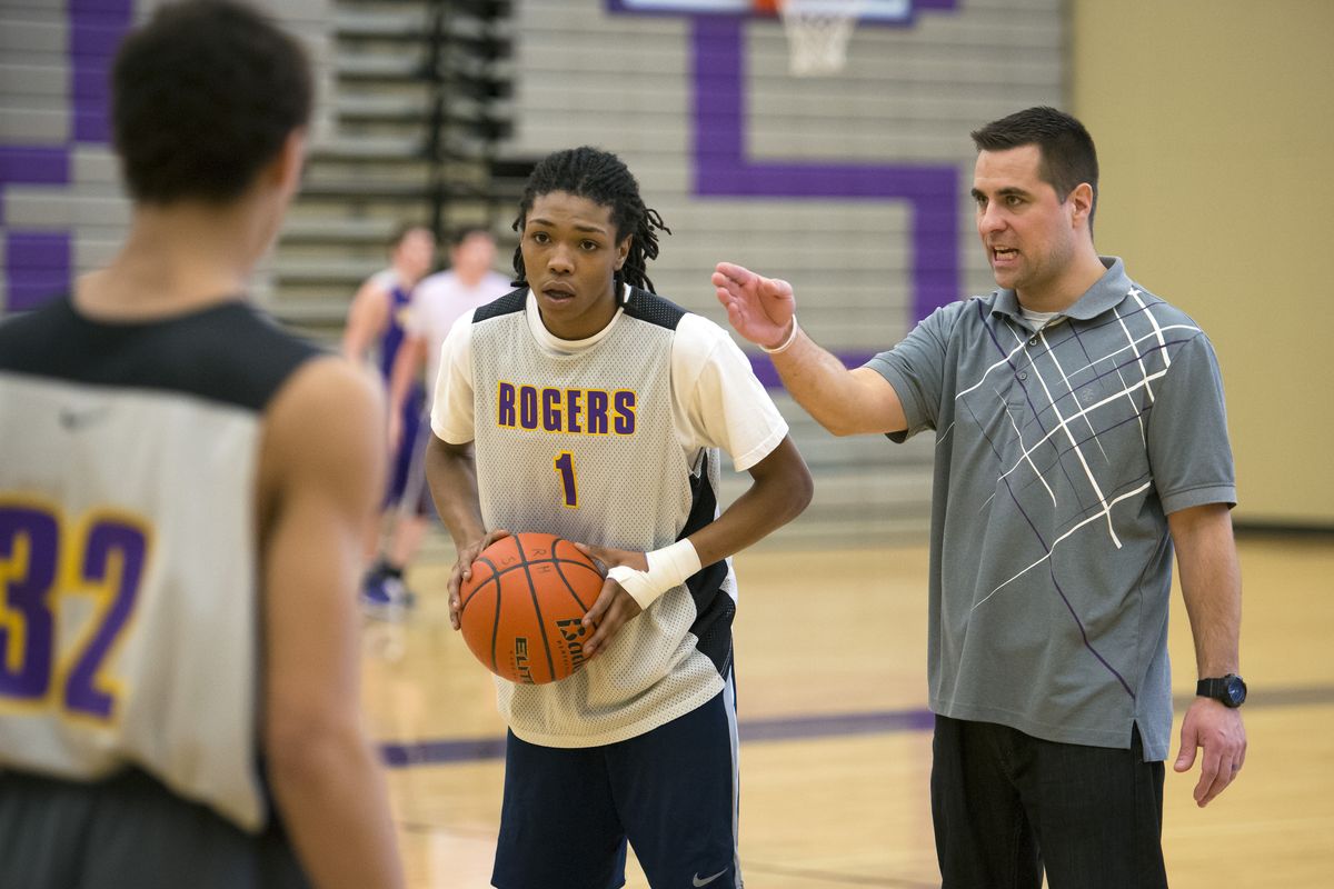 Rogers head coach Joel Soter gives guard Asante Fields directions during practice Tuesday in the school gym. (Colin Mulvany)