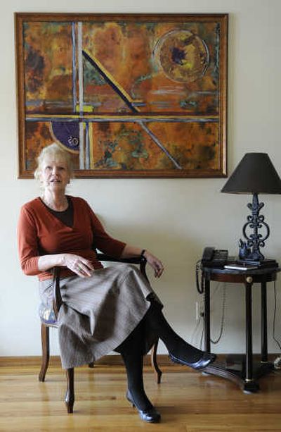 
Irene Dahl sits in front of her artwork, 