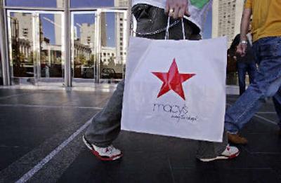 
A shopper leaves a Macy's department store in San Francisco. Federated Department Stores Inc., owner of the Macy's and Bloomingdale's chains, on Wednesday said it lost $3 million in the third quarter  mostly because of  costs related to its acquisition of May Department Stores. 
 (Associated Press / The Spokesman-Review)