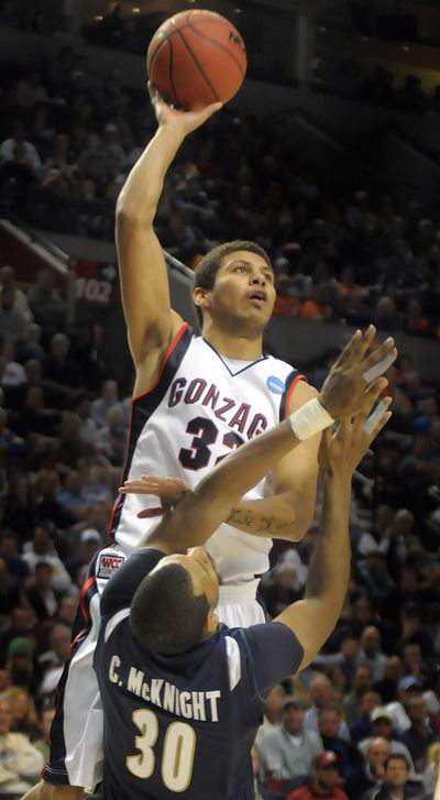 #32 Steven Gray of Gonzaga leaps over #30 Chris McKnight during second half action against Akron in the opening round of the NCAA Tournament in the Portland Oregon Rose Garden Thursday, March 19, 2009.   Gray was called for a foul on the play as Gonzaga pulled out a 77-64 win.  (Christopher Anderson / The Spokesman-Review)