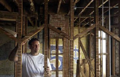 
Rob Brewster, of ConoverBond, has projects under way in Spokane and Spirit Lake, Idaho. Workers uncovered an old cigar ad on the wall of a building he's renovating into apartments as part of his Havermale Park project. 
 (Jed Conklin / The Spokesman-Review)