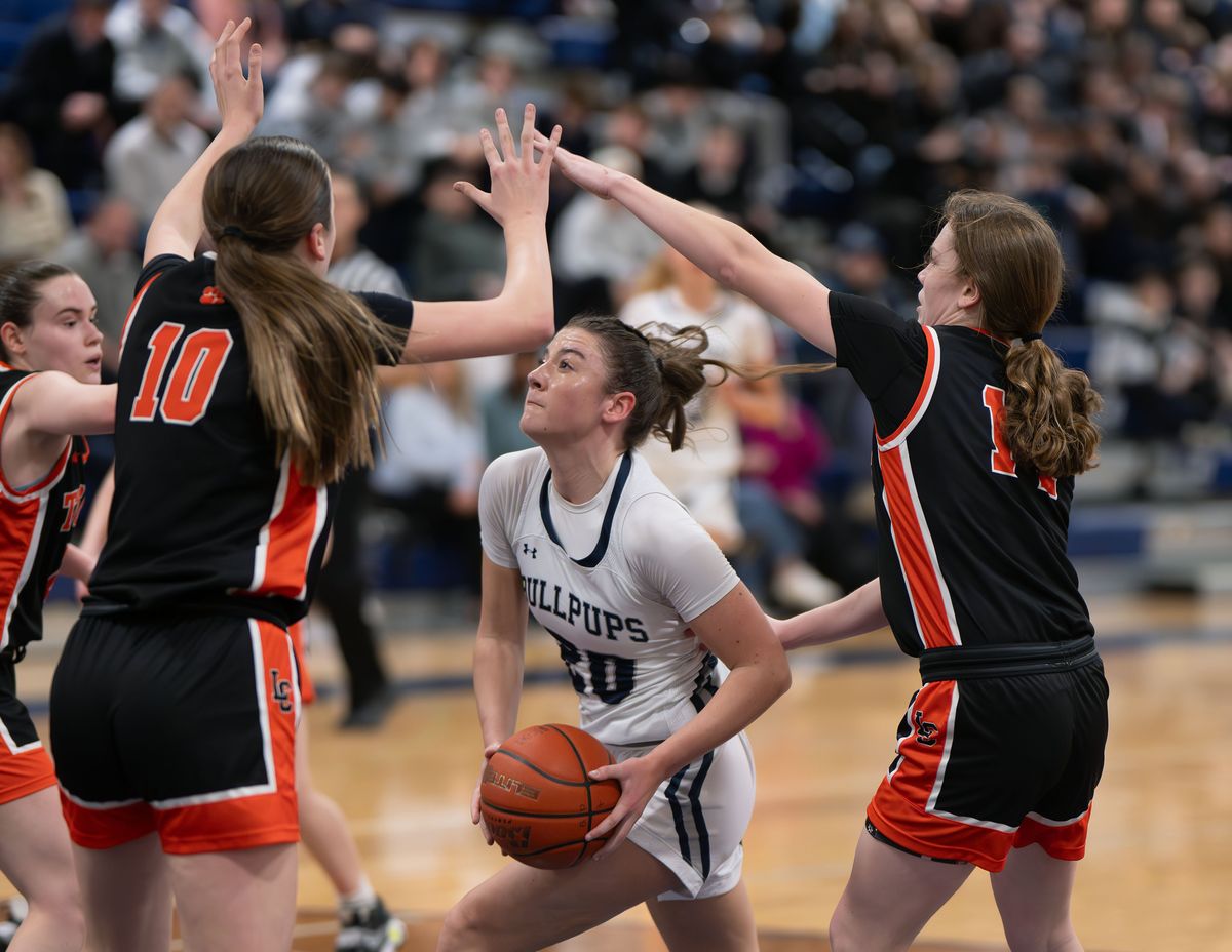 Gonzaga Prep guard Olivia McIntyre enters the key as Lewis and Clark forward Presley Barkstorm, left, and guard Rhiannon Kilgore defend during a January game.  (COLIN MULVANY/THE SPOKESMAN-REVIEW)