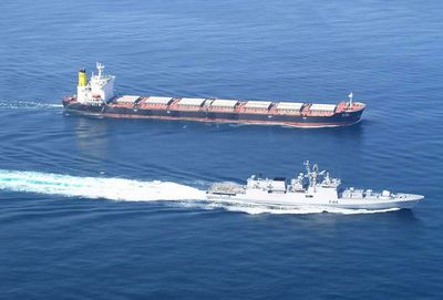 In this Nov. 11 photo, Indian warship INS Tabar, bottom, escorts the MV Jag Arnav ship to safety after rescuing it from a hijack attempt by Somali pirates.  (Associated Press / The Spokesman-Review)
