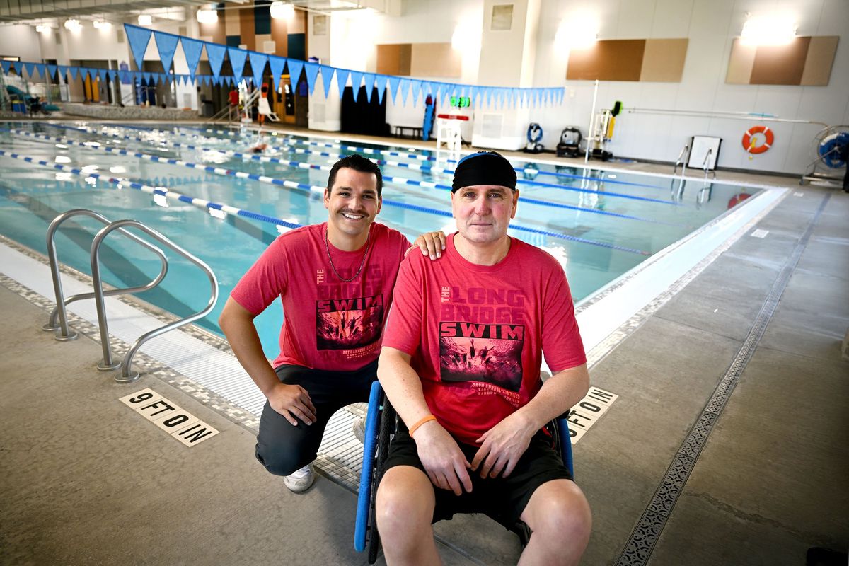 Seth Peterson, left, and his dad, Tom Peterson, are photographed Aug. 10 at the Airway Heights Recreation Center pool. They completed the Long Bridge swim together on Aug. 5 in Sandpoint.  (Kathy Plonka/THE SPOKESMAN-REVIEW)