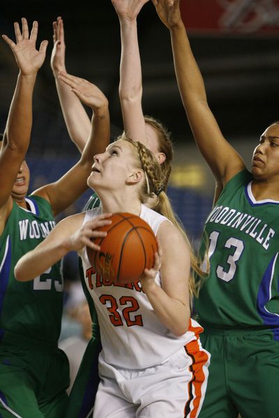 Lewis and Clark's Hayley Hendricksen, middle, finds herself under the basket surrounded by Woodinville defenders during action at the 4A State Basketball Tournament Friday at the Tacoma Dome. (Patrick Hagerty / Special to The Spokesman-Review)