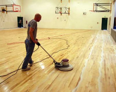 
Bruce Kapron, of Big Sky Suppplies, sands the floor of the gymnasium at West Ridge Elementary in Post Falls. The new school opens this fall. 
 (Taryn Hecker / The Spokesman-Review)