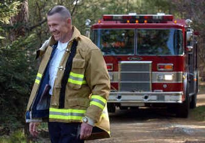 
New Spokane Valley Fire Chief Mike Thompson heads for a home in the Dishman Hills area during the Spokane Valley Fire Department wildland interface urban training. Thompson was a fire chief in Culver City, Calif. 
 (Liz Kishimoto / The Spokesman-Review)