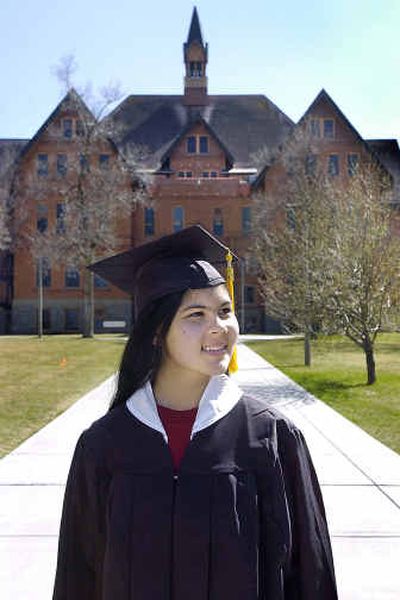 
MSU's youngest graduate, Promethea Pythaitha, stands in front of  Main Hall. 
 (Associated Press / The Spokesman-Review)