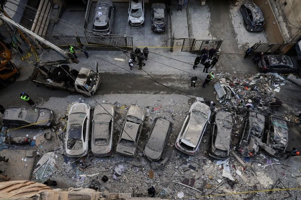 Debris and damaged vehicles at the site of an Israeli strike on an apartment building, in central Beirut, Lebanon, March 11, 2026, following an escalation between Hezbollah and Israel amid the U.S.-Israeli conflict with Iran.   (Emilie Madi/Reuters)