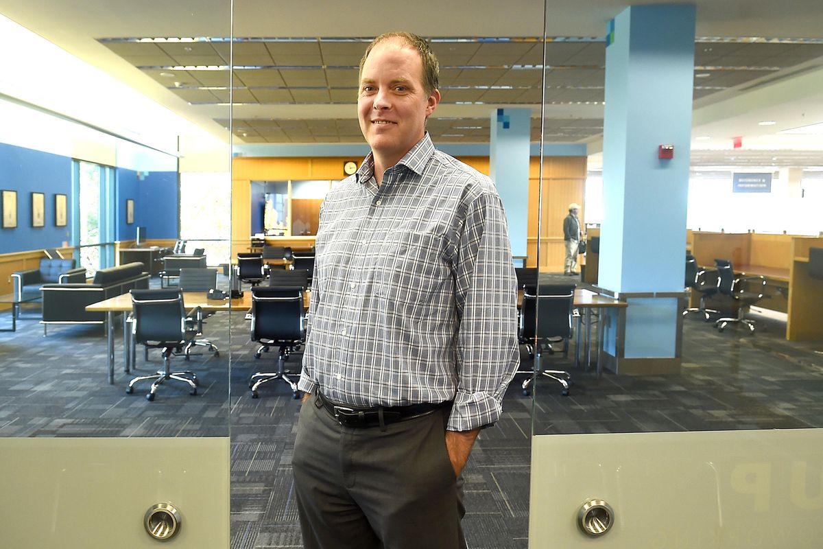 Mark Pond, a reference librarian at the Spokane Public Library, stands in the doorway of the conference room in the new coworking space in the downtown library Tuesday, Oct. 25, 2016. The new space offers the use of desks, the conference room, a classroom and two Mac computers set up to work on visuals and graphics. There is also a Bloomberg terminal, a computer that provides in-depth, real-time business information. It is an expensive proprietary system usually found only in the offices of financial professionals. The classroom has a smartboard for displaying and interacting with graphics. (Jesse Tinsley / The Spokesman-Review)