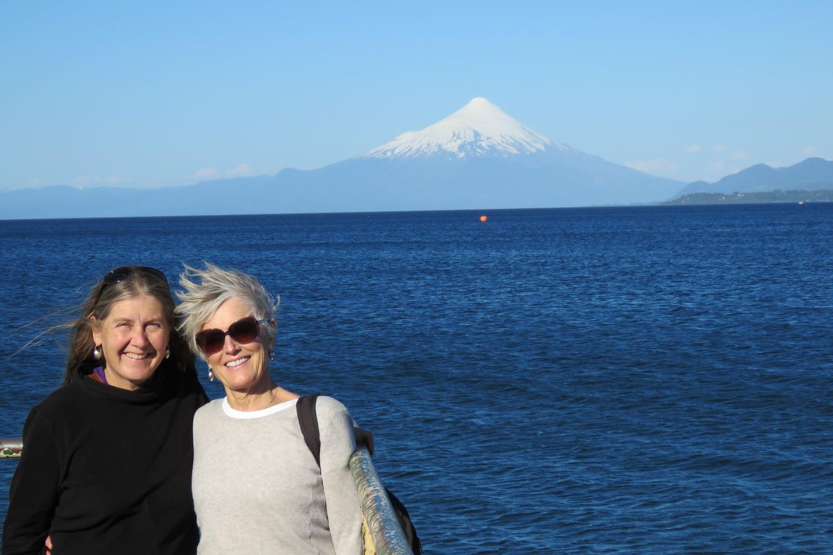 Denise Attwood (left) and Nancy Schaub are photographed with the the Osorno volcano on lake Llanquihui in Puerto Varas Chile in the background. (Ric Conner / Courtesy)