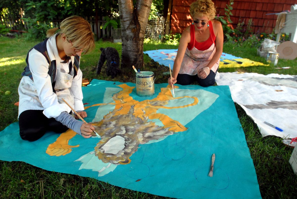 Artists Robin Nelson Wicks, right, and her daughter, Hannah Nelson Wicks, 15, paint canvas images from “The Wizard of Oz” July 24 that will be put up during Garland Street Fair. (Jesse Tinsley / The Spokesman-Review)
