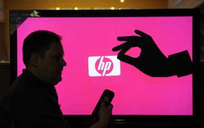 Brian Weaver, an HP sales representative, is silhouetted against an HP MediaSmart LCD HDTV on display at Huppin's in Spokane. The television uses wireless technology for streaming movies, photos and music from a computer. 
 (Dan Pelle / The Spokesman-Review)