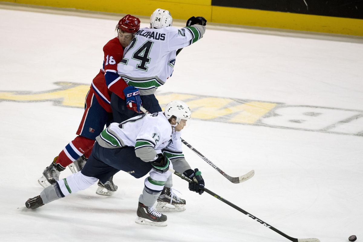 Spokane center Curtis Miske (18) and Seattle defenseman Brandon Schuldhaus (24) compete for the puck during the first period of a WHL hockey game in the Spokane Arena, Tues., Nov. 15, 2016. (Colin Mulvany / The Spokesman-Review)