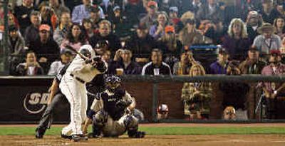
San Francisco's Barry Bonds swings for his 700th career home run off San Diego's Jake Peavey in the third inning Friday. 
 (Associated Press / The Spokesman-Review)
