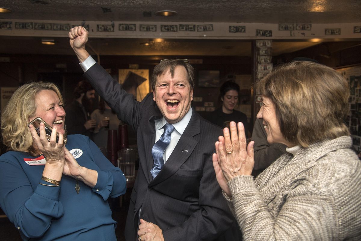 Spokane City Councilman Breean Beggs erupts with delight after viewing election results on a smartphone with his wife, Laurie Powers, left and fellow council member Lori Kinnear, Tuesday, Nov. 7, 2017, at O’Doherty’s Irish Grill in downtown Spokane, Wash. Beggs lead over challenger Andy Dunau with 57% of the vote after the initial ballot count for Spokane City Council Position #2. (Dan Pelle / The Spokesman-Review)