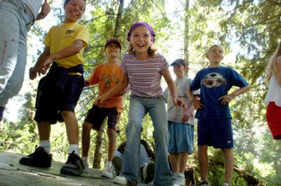 
Sarah Holt, 10, center, balances on a teetering platform with fellow campers at the Shoshone Work Center on Tuesday. The center is an old lodging site for Forest Service workers. It is now being purchased by Lutherhaven, a Lutheran camp and retreat center currently on Lake Coeur d'Alene. 
 (Photos by JESSE TINSLEY / The Spokesman-Review)