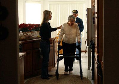 
 Stella Martin, left, helps her mom Lou Jean Evans and her dad John into the living room after a snack in her Greenacres home. Martin's parents moved in with her about a year ago. 
 (Liz Kishimoto / The Spokesman-Review)