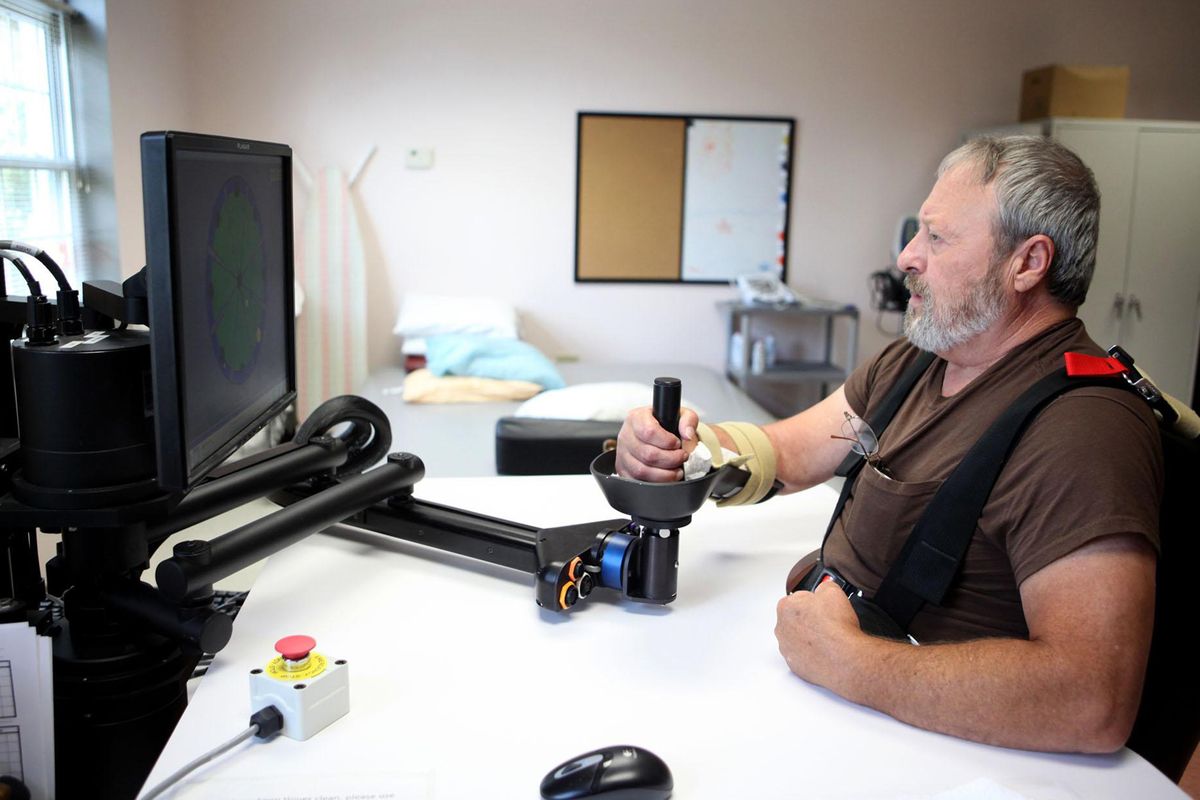 Michael Begley, a patient at Cardinal Hill Rehabilitation Center in Lexington, Ky., uses computer and robot equipment to help regain use of his arm during therapy for a stroke. McClatchy-Tribune photos (McClatchy-Tribune photos / The Spokesman-Review)