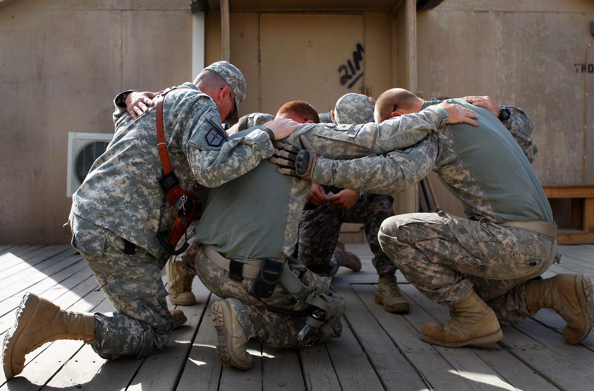 Nebraska Army National Guard soldiers pray together before heading out to meet Afghan farmers to provide development assistance and farming advice. Los Angeles Times (Los Angeles Times / The Spokesman-Review)