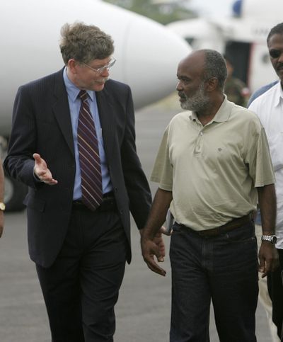 FILE - Tim Carney, then the top U.S. diplomat in Haiti, talked with Haitian presidential candidate Rene Prevalin 2006. Carney has been named interim executive director of the Northwest Museum of Arts and Culture in Spokane. (BRENNAN LINSLEY / AP)