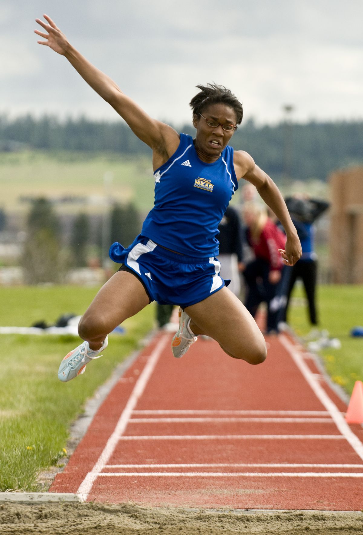 Mead senior Kiersten Green lands a winning triple jump of 34 feet, 7 inches.  (Colin Mulvany / The Spokesman-Review)