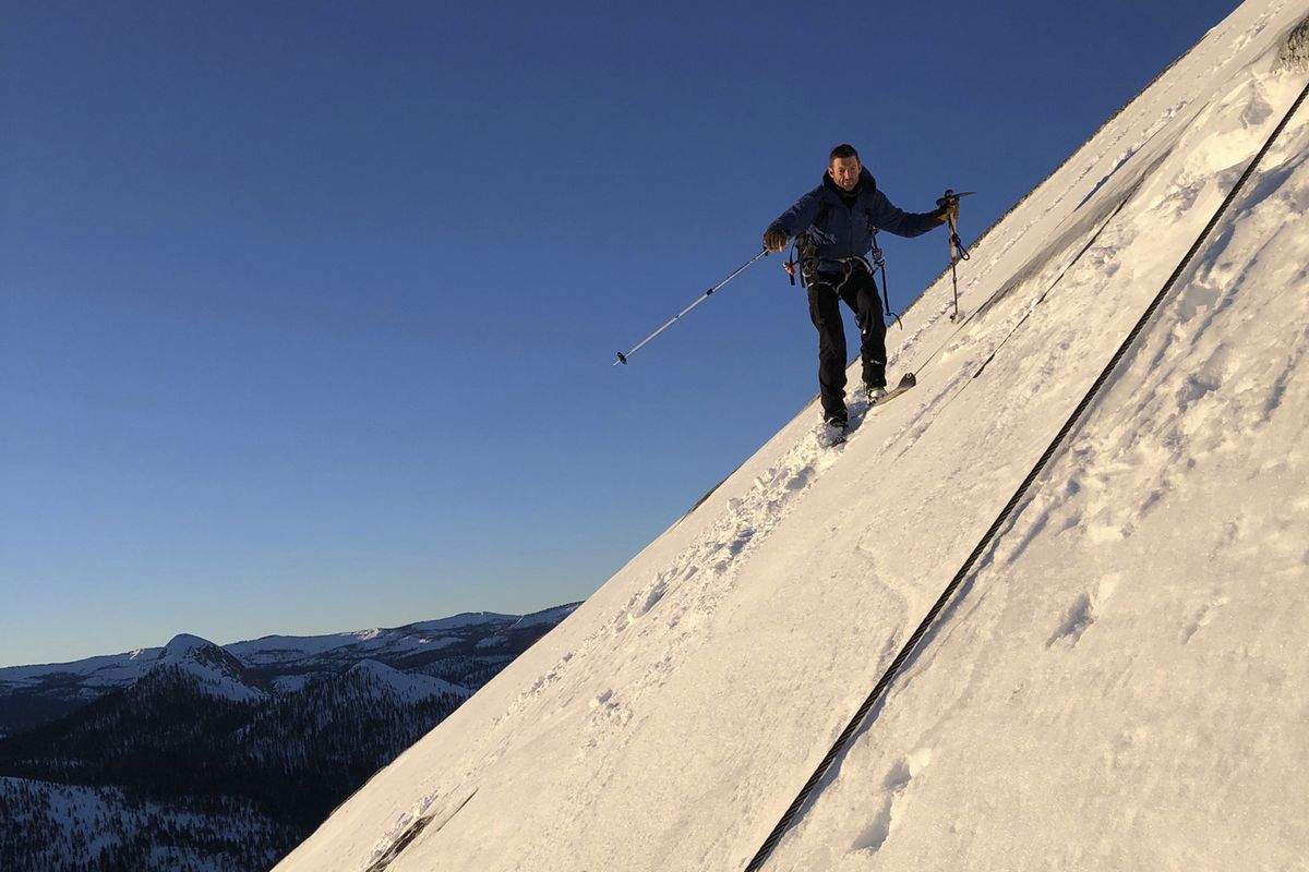 In this photo provided by Jason Torlano, Zach Milligan is shown on his descent down Half Dome in Yosemite National Park, Calif., on Sunday, Feb. 21, 2021. Two men climbed some 4,000 feet to the top of Yosemite